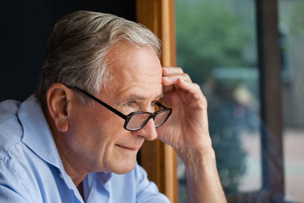 Close up of senior sitting at table Close up of senior sitting at table