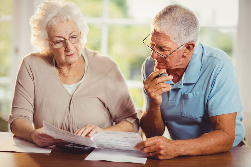 Senior couple counting bills