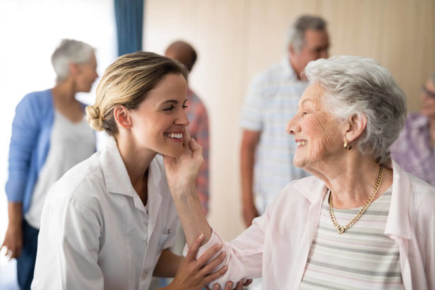 Senior woman touching smiling female doctor Senior woman touching smiling female doctor