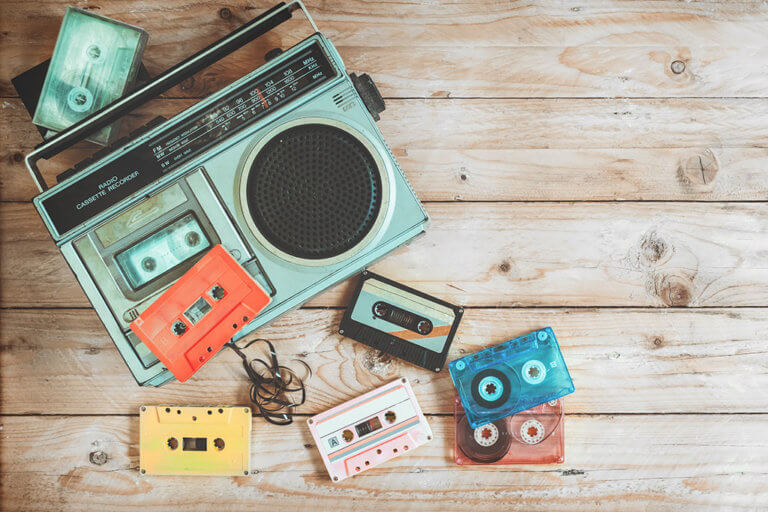 Top view hero header - retro technology of radio cassette recorder music with retro tape cassette on wood table