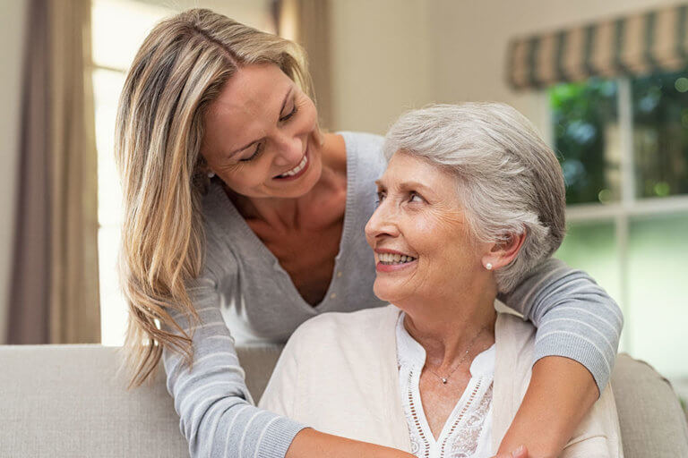 Woman embracing senior mother