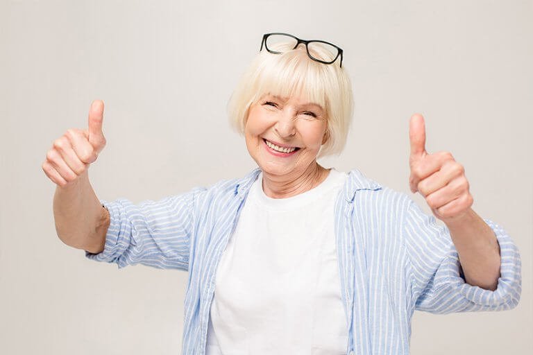 Portrait of cheerful mature woman giving thumb up