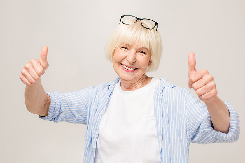 Portrait of cheerful mature woman giving thumb up