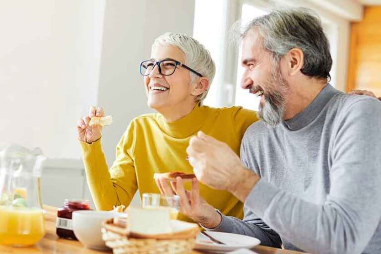 senior couple breakfast home food lifestyle eating table home man woman together husband wife family