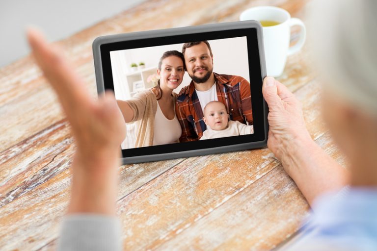 family having video call on tablet computer