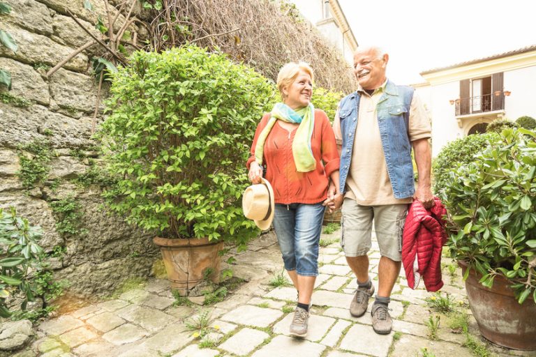 Happy senior couple walking holding hand in San Marino old town