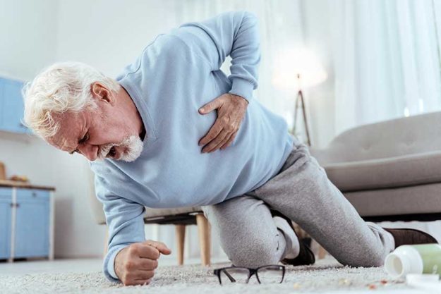 Severe pain. Low angle of shocked senior man shouting and touching chest Severe pain. Low angle of shocked senior man shouting and touching chest