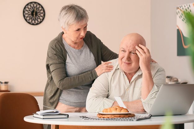 Stressed senior couple in debt at home
