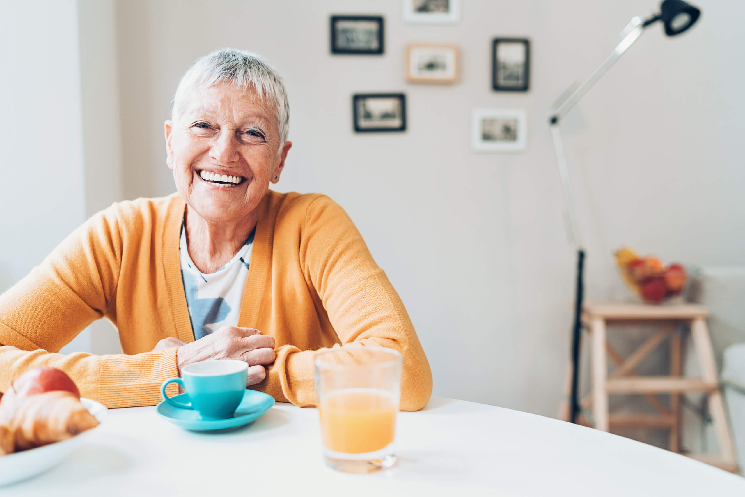 Senior women in yellow sweater smiling