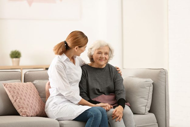 Elderly woman with female caregiver