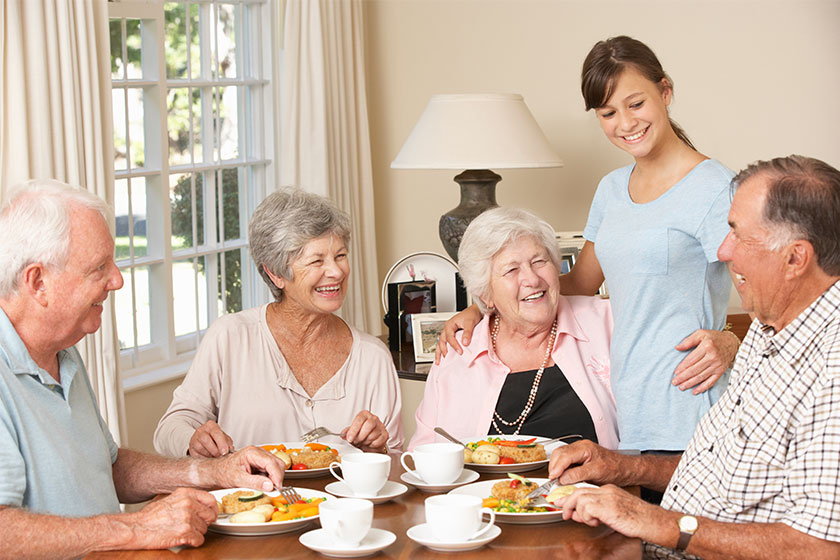 roup Of Senior Couples Enjoying Meal Together