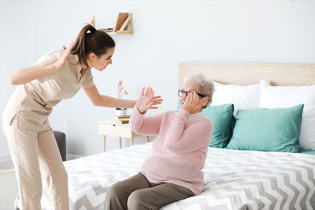 Caregiver mistreating senior woman Caregiver mistreating senior woman