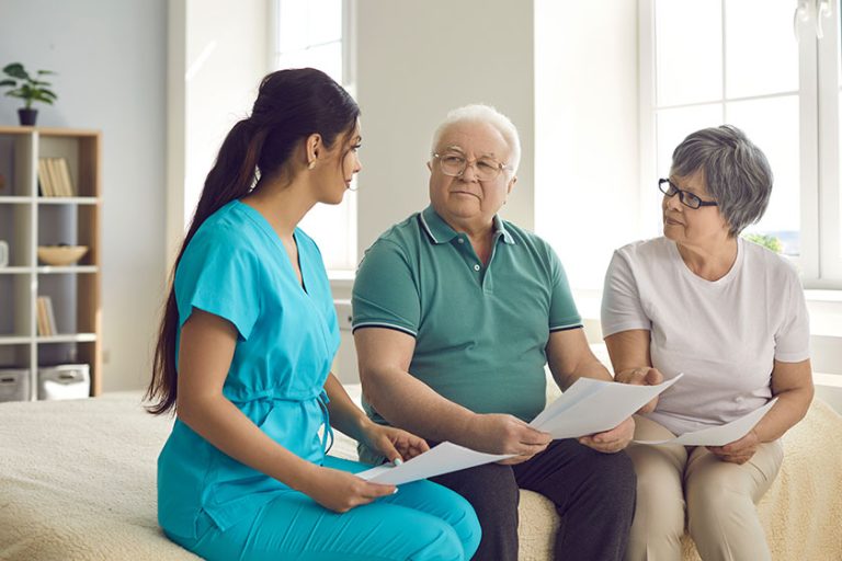 Caretaker helps senior patients sign homecare agreement