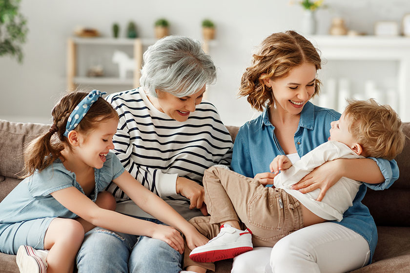 Multi generational relatives having fun on sofa. Multi generational relatives having fun on sofa.