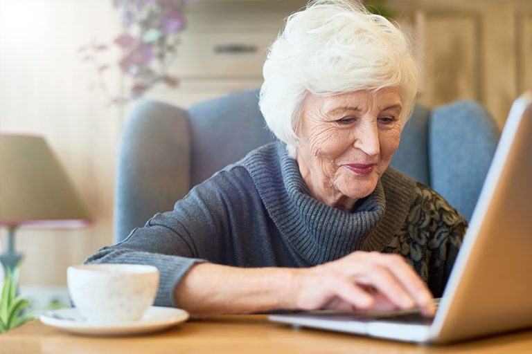 Smiling aged manager wearing knitted sweater
