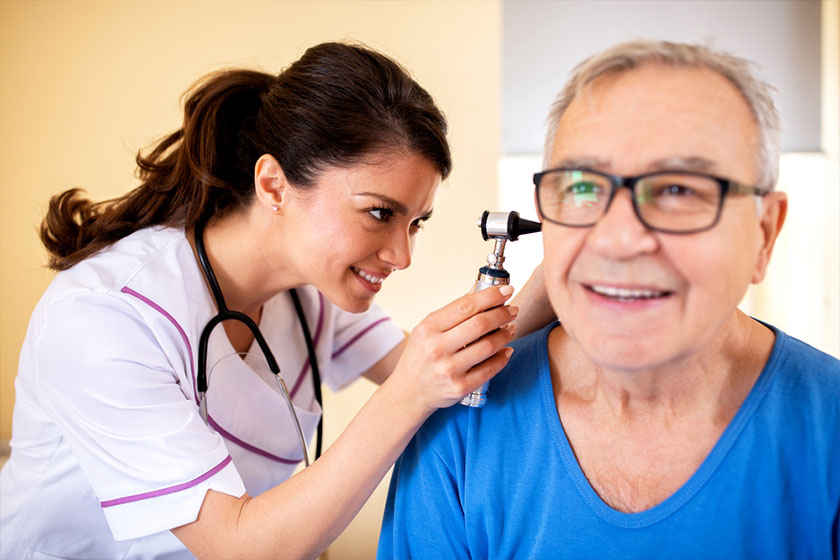 doctor-using-otoscope-to-check-on-elder-mans-ear doctor-using-otoscope-to-check-on-elder-mans-ear