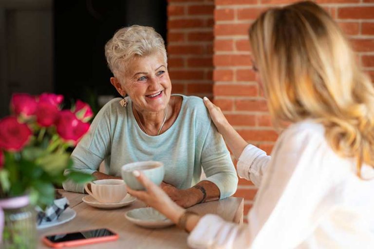 Happy senior mother talkinf with adult daughter