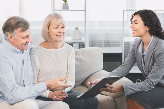 Senior couple consulting with adviser at office Senior couple consulting with adviser at office