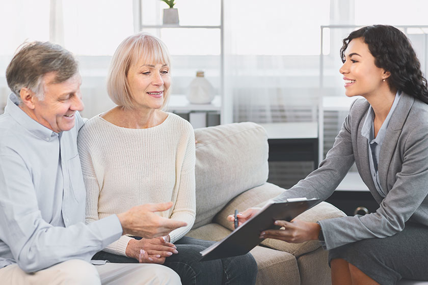 Senior couple consulting with adviser at office Senior couple consulting with adviser at office