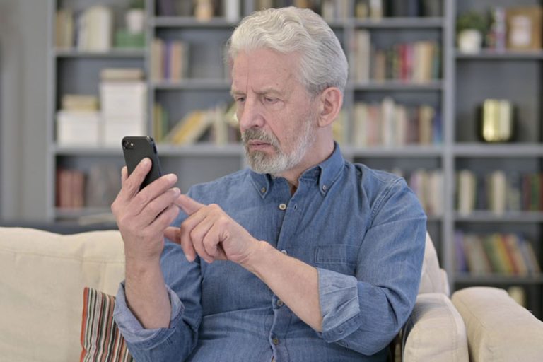 Senior man using smartphone