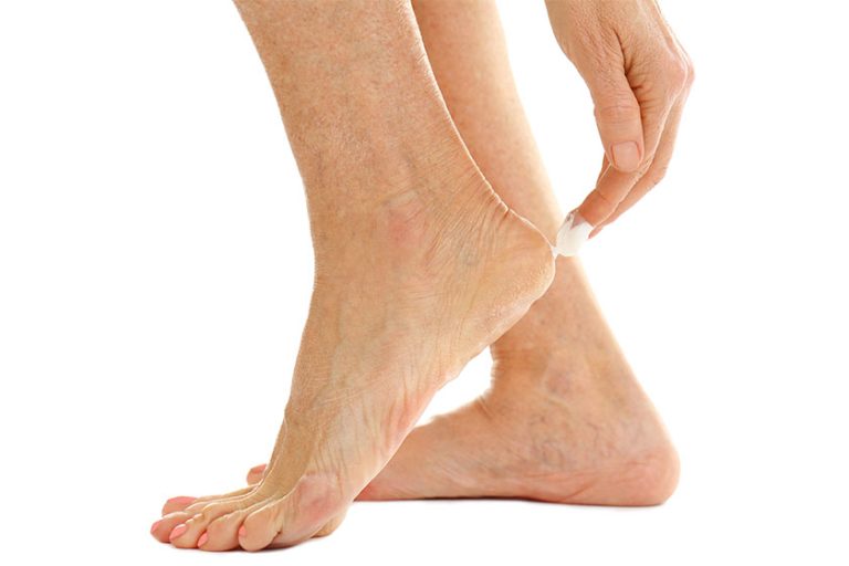 Female hand applying cosmetic cream