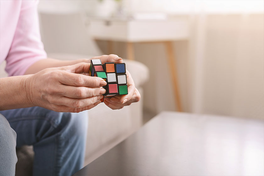 Old woman holding Rubiks cube