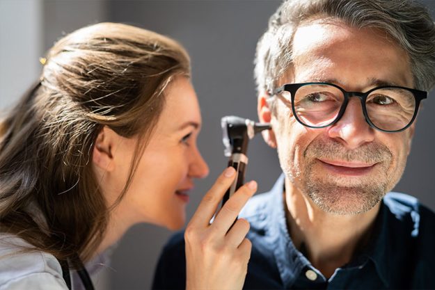 Ear Check Using Otoscope Doctor Examining Patient