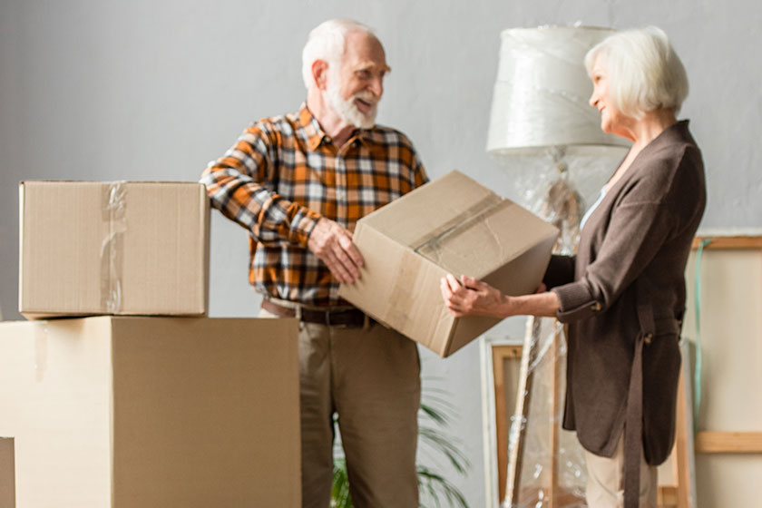 Senior Couple Holding Cardboard Box New House Senior Couple Holding Cardboard Box New House