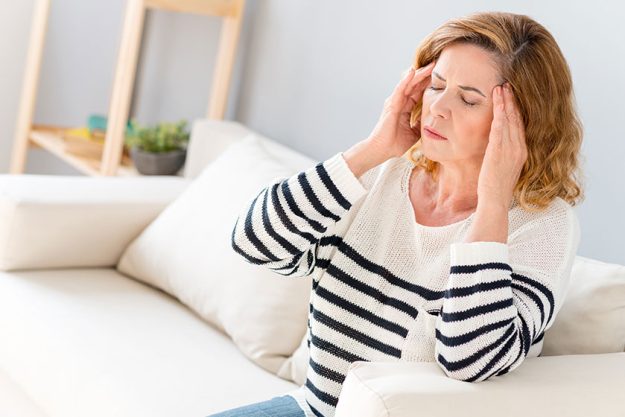 Senior woman feels pain in head