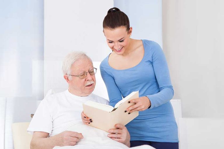 caretaker-and-senior-man-reading