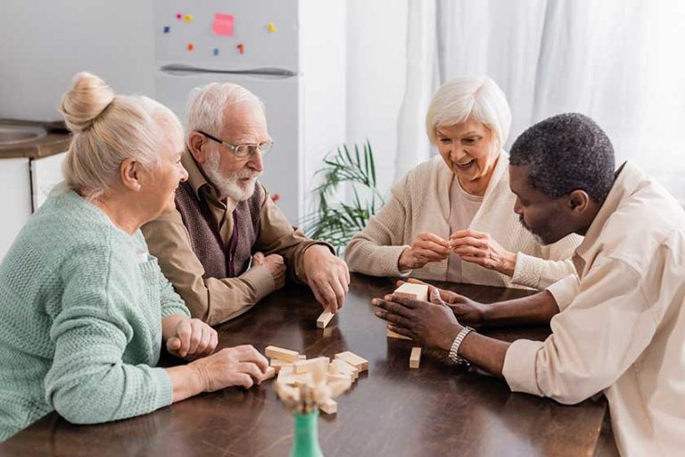 Excited senior woman smiling while playing tower