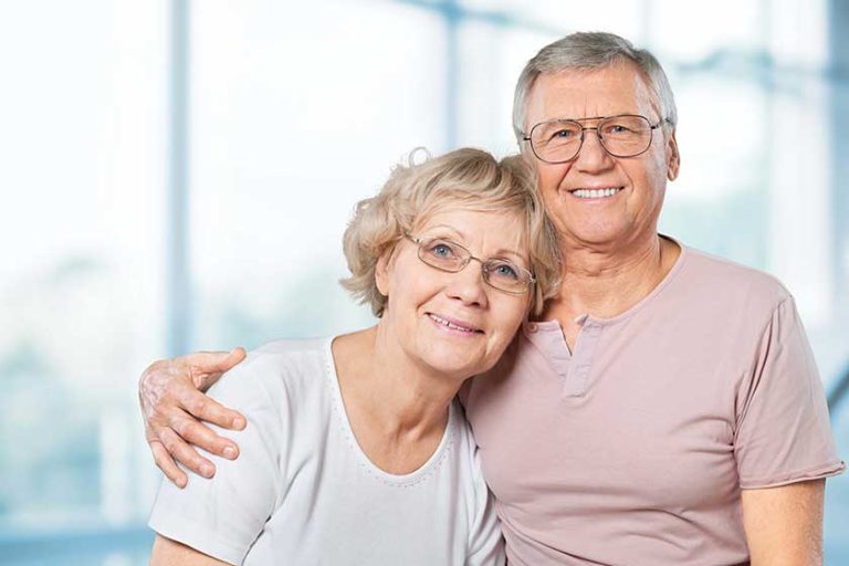 Happy senior couple smiling at home