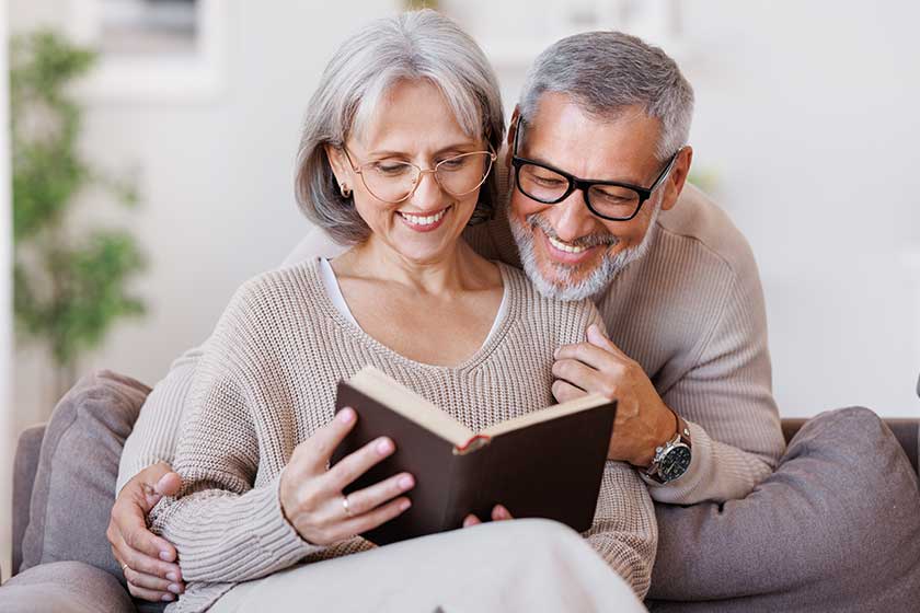 Happy smiling senior family couple in love reading book Happy smiling senior family couple in love reading book