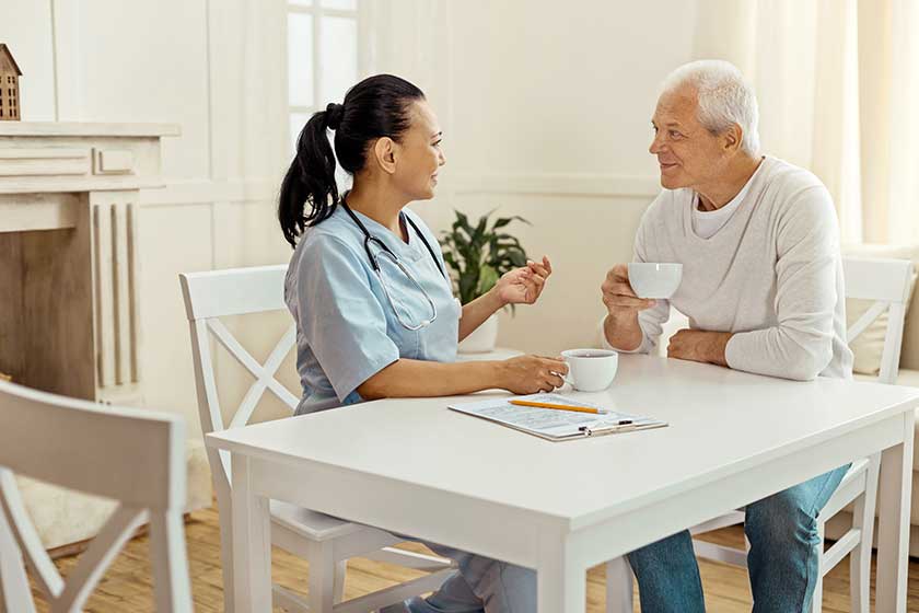 Joyful delighted man listening to his caregiver