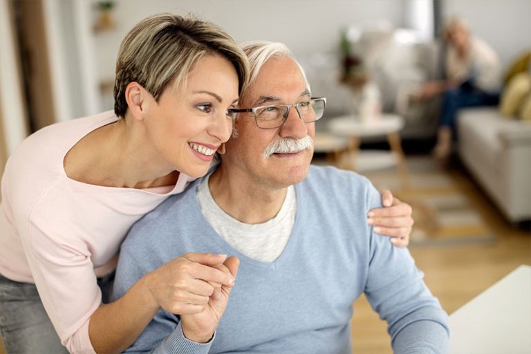 Happy woman embracing her senior father