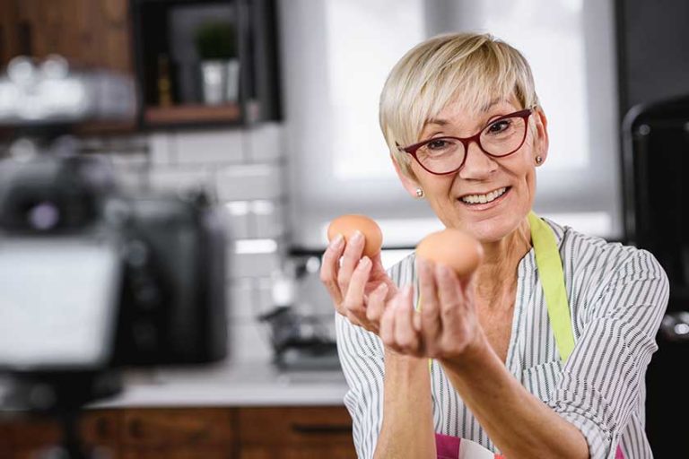 Senior woman food blogger filming recipe