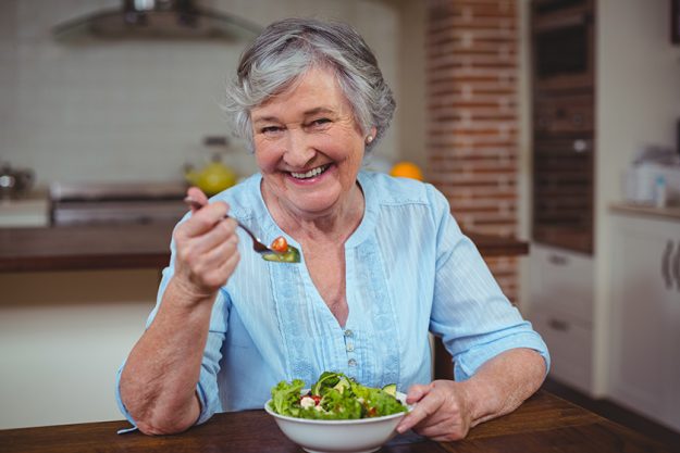 Woman having vegetable salad