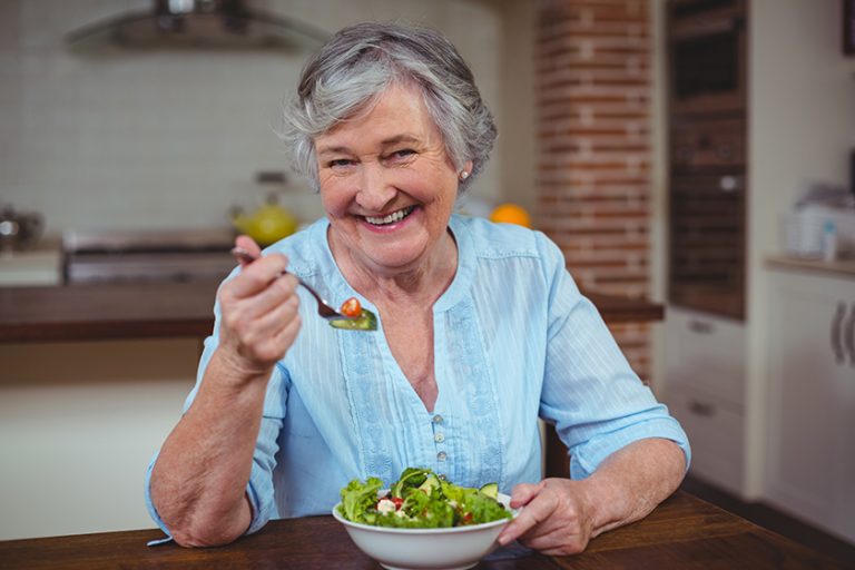 Woman having vegetable salad