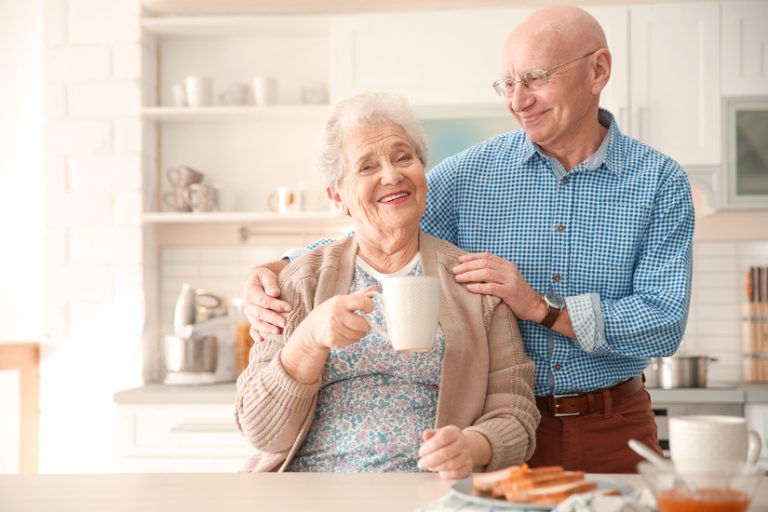 Elderly couple having breakfast in kitchen