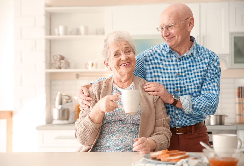 Elderly couple having breakfast in kitchen