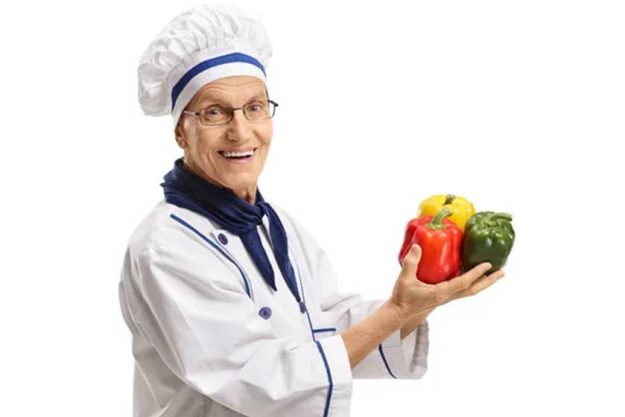 Elderly chef with peppers
