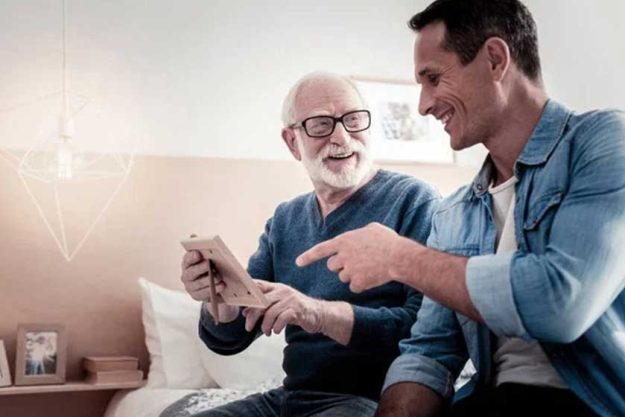 Happy positive man pointing at the photo Happy positive man pointing at the photo