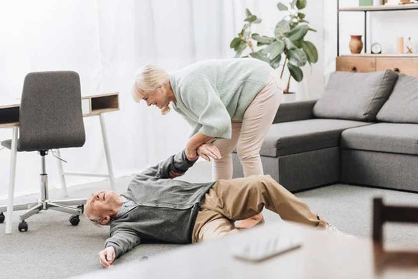 Old woman helping to husband who falled down on floor