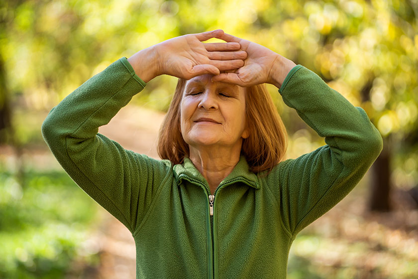 Senior woman is practicing Tai Chi exercise in park
