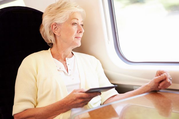 Senior woman traveling by train