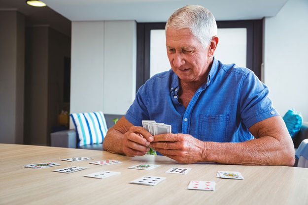senior man playing cards