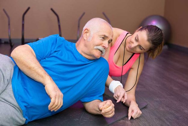 elderly man doing side plank