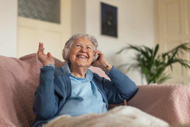 portrait senior woman sitting home calling eldery woman talking smartphone