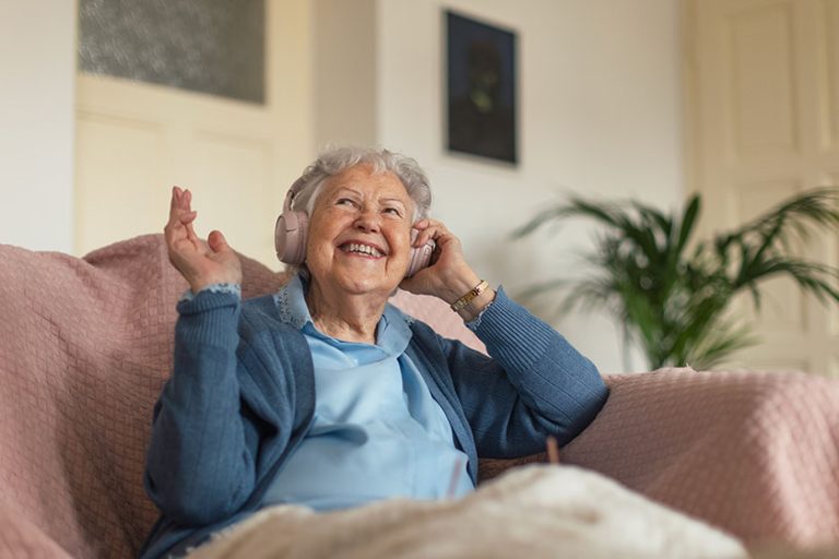 portrait senior woman sitting home calling eldery woman talking smartphone