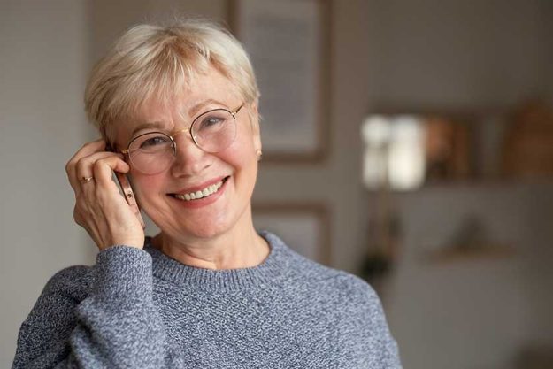 senior woman smiling talking on phone at home senior woman smiling talking on phone at home